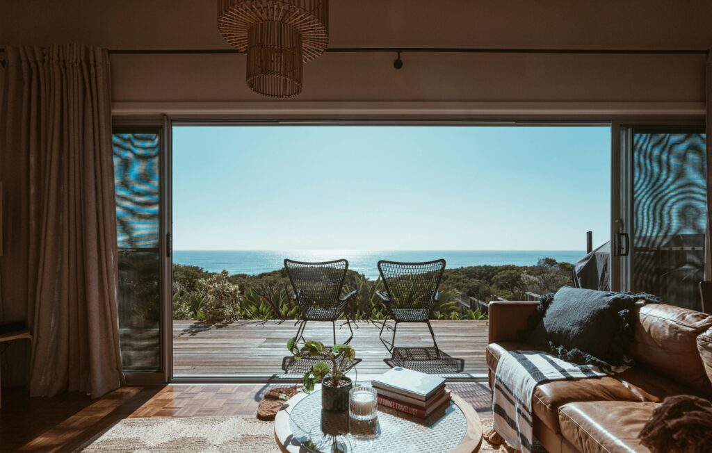 a living room with a view of the ocean from the deck CapitalOnTap Free