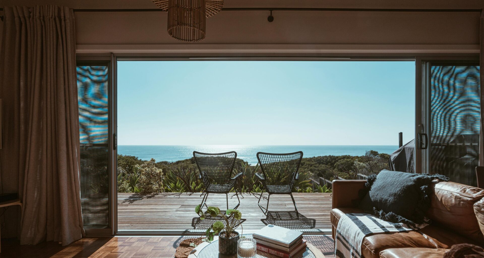 a living room with a view of the ocean from the deck CapitalOnTap Free