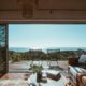 a living room with a view of the ocean from the deck CapitalOnTap Free