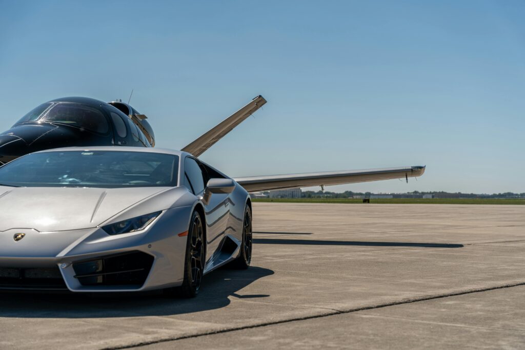 a silver sports car parked on a runway avis Hertz