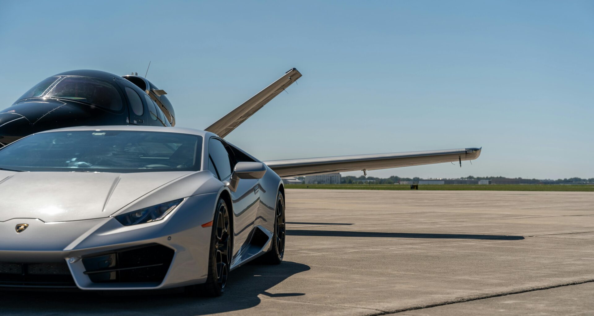 a silver sports car parked on a runway avis Hertz