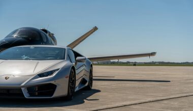 a silver sports car parked on a runway avis Hertz