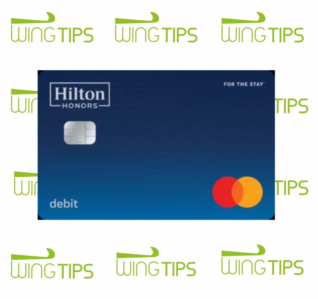 a blue credit card with a white and red logo Hilton Honors Debit Card.