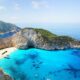 a beach with boats and blue water BA Freebird