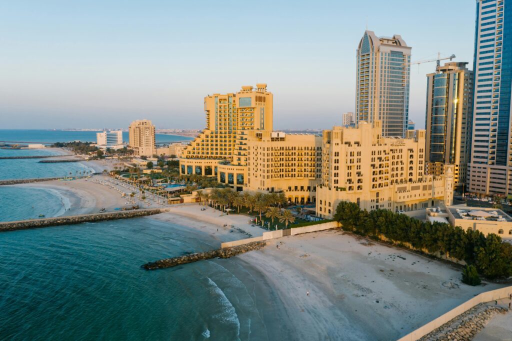 a beach with buildings and trees Radisson Rewards