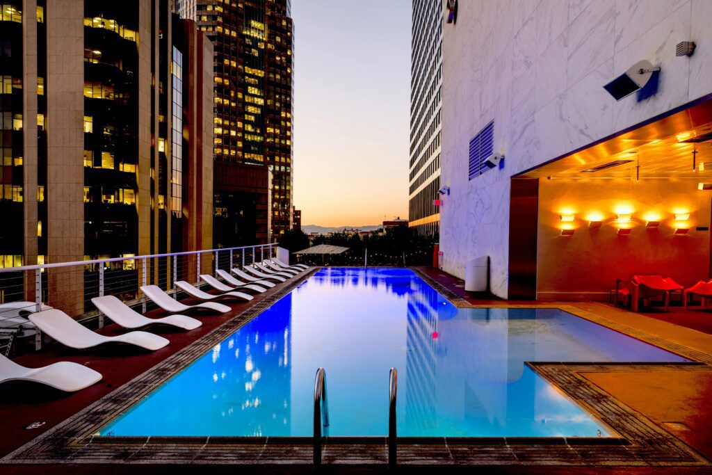 a pool with chairs around it American Express Preferred Rewards
