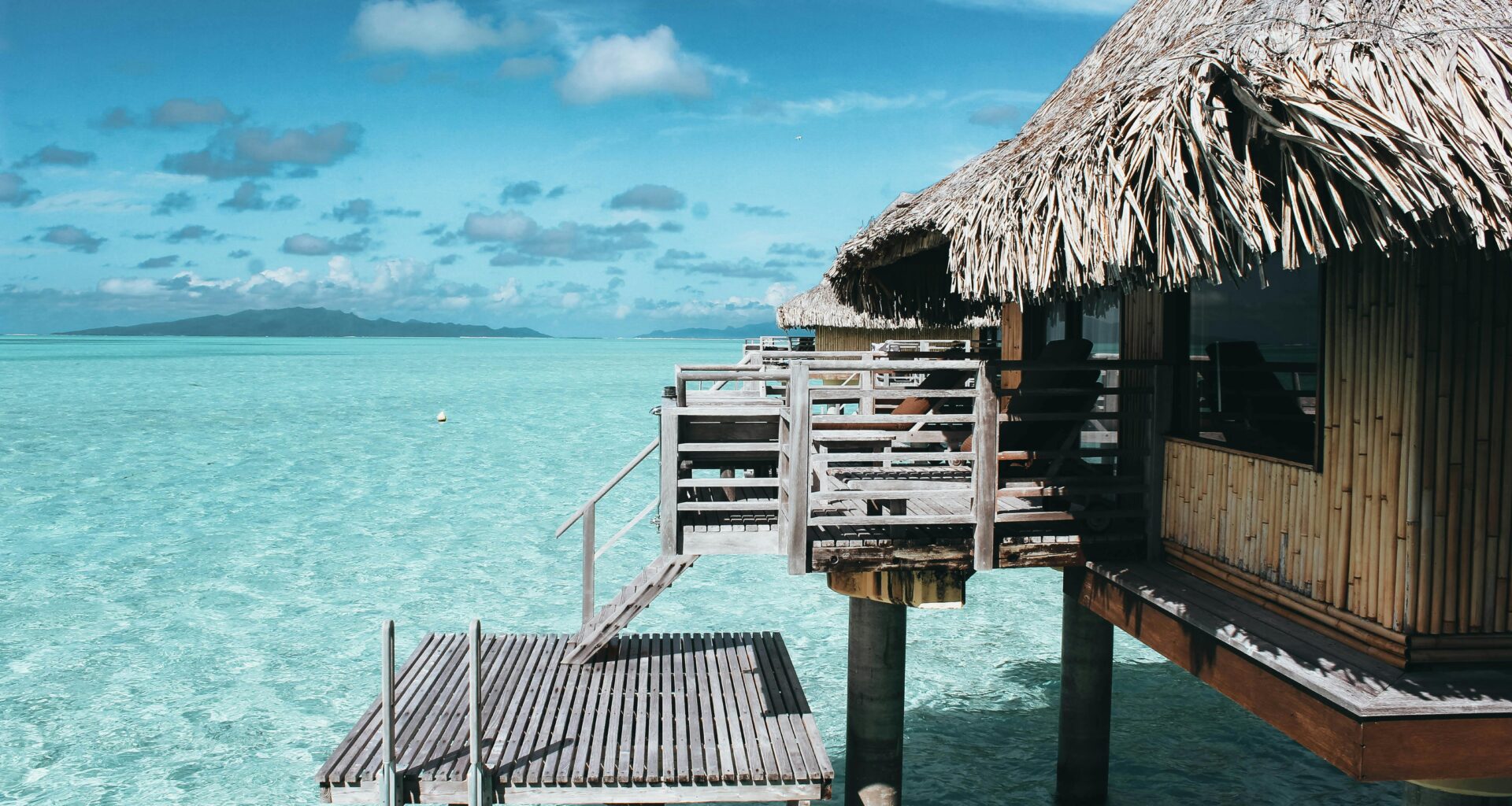 a building on stilts over water American express