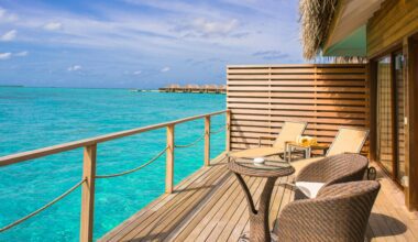 a deck with chairs and a table overlooking the ocean British Airways VS Virgin Atlantic