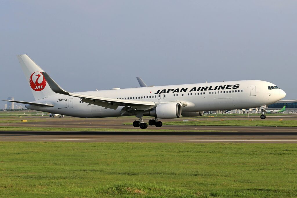 a white airplane taking off JAL boeing 737 order