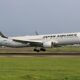 a white airplane taking off JAL boeing 737 order