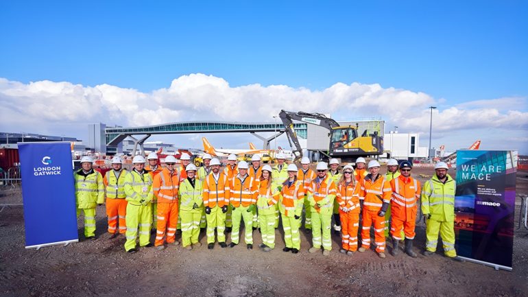 a group of people in orange uniforms Gatwick Airport expansion 