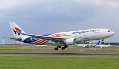 a plane taking off from a runway Malaysia airlines Boeing 737