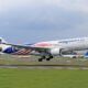 a plane taking off from a runway Malaysia airlines Boeing 737