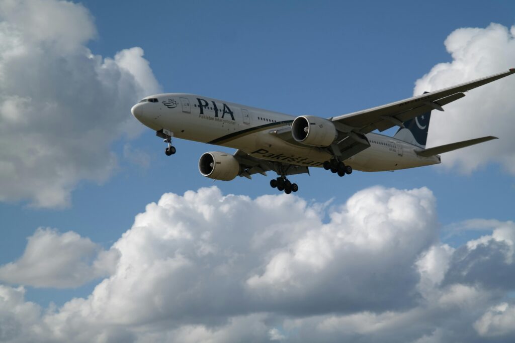 a plane flying in the sky PIA UK flights