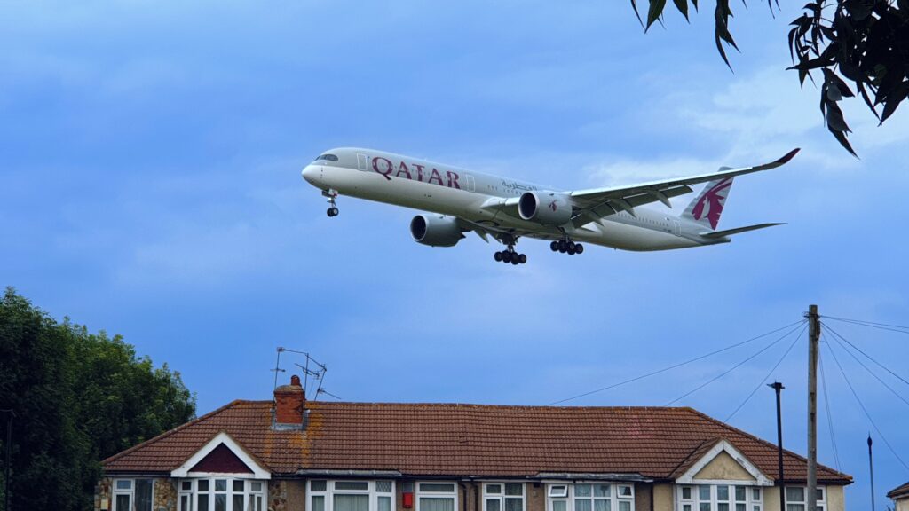 a plane flying in the sky Qatar