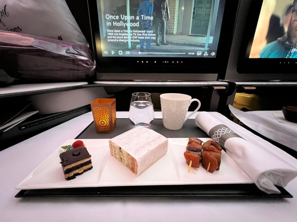 a tray with food on it and a tv on the screen