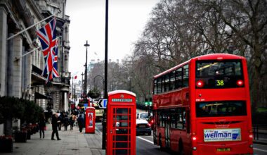 a double decker bus on the street UK passport fees 2025