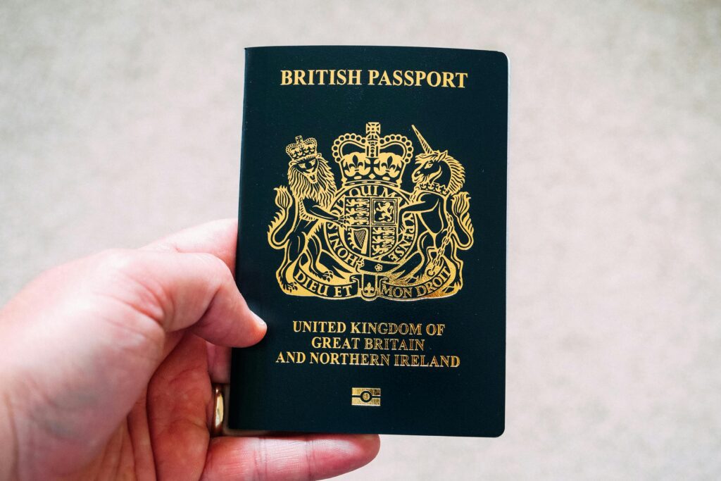 a hand holding a passport UK passport fees 2025