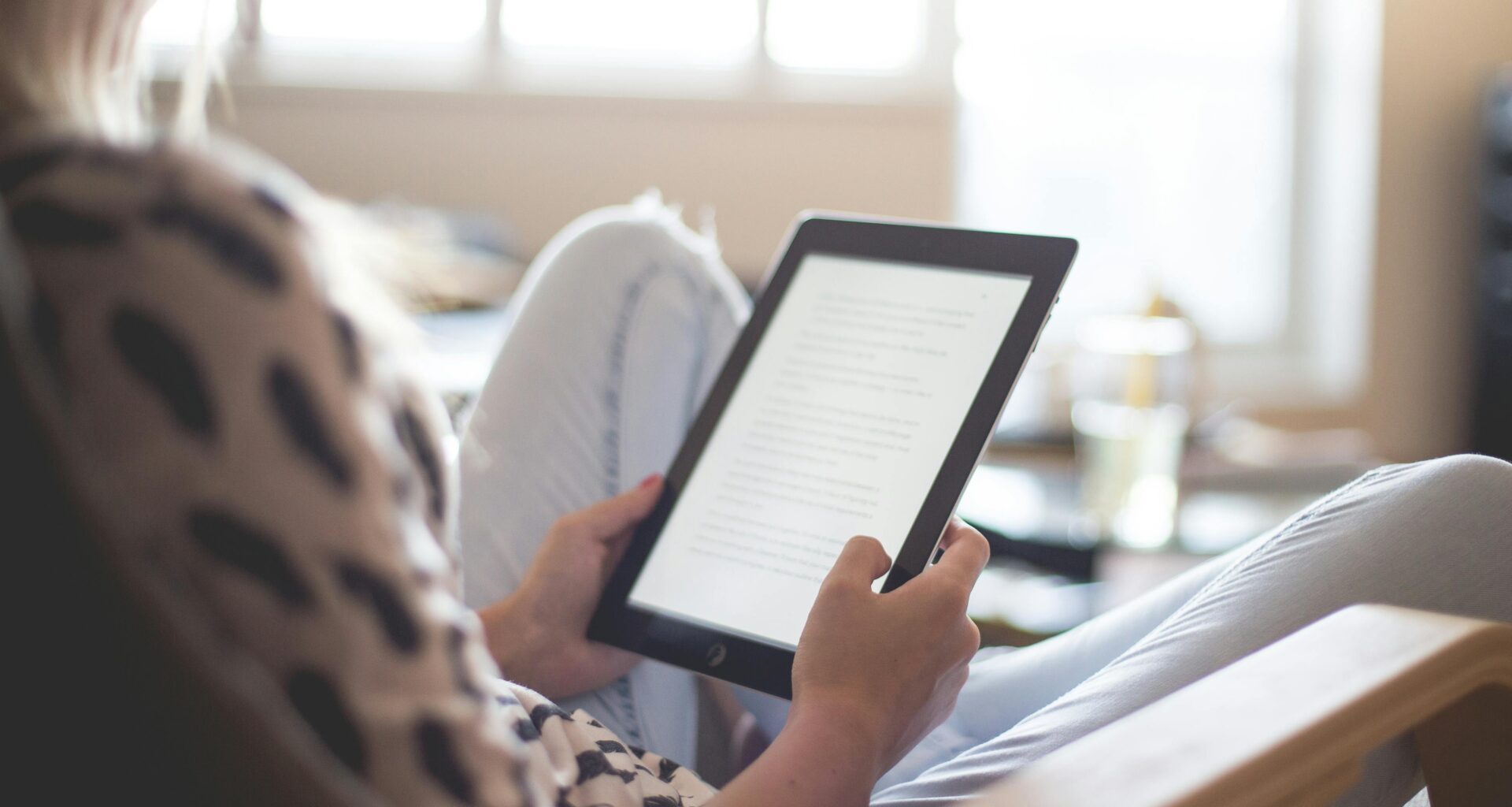 a person holding a tablet wingtips weekly