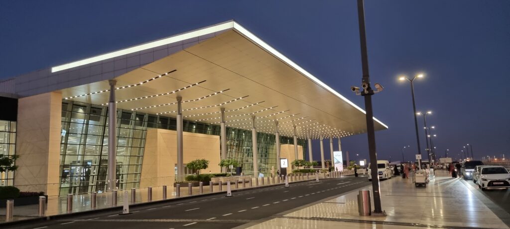a building with a large roof and a street airport architecture
