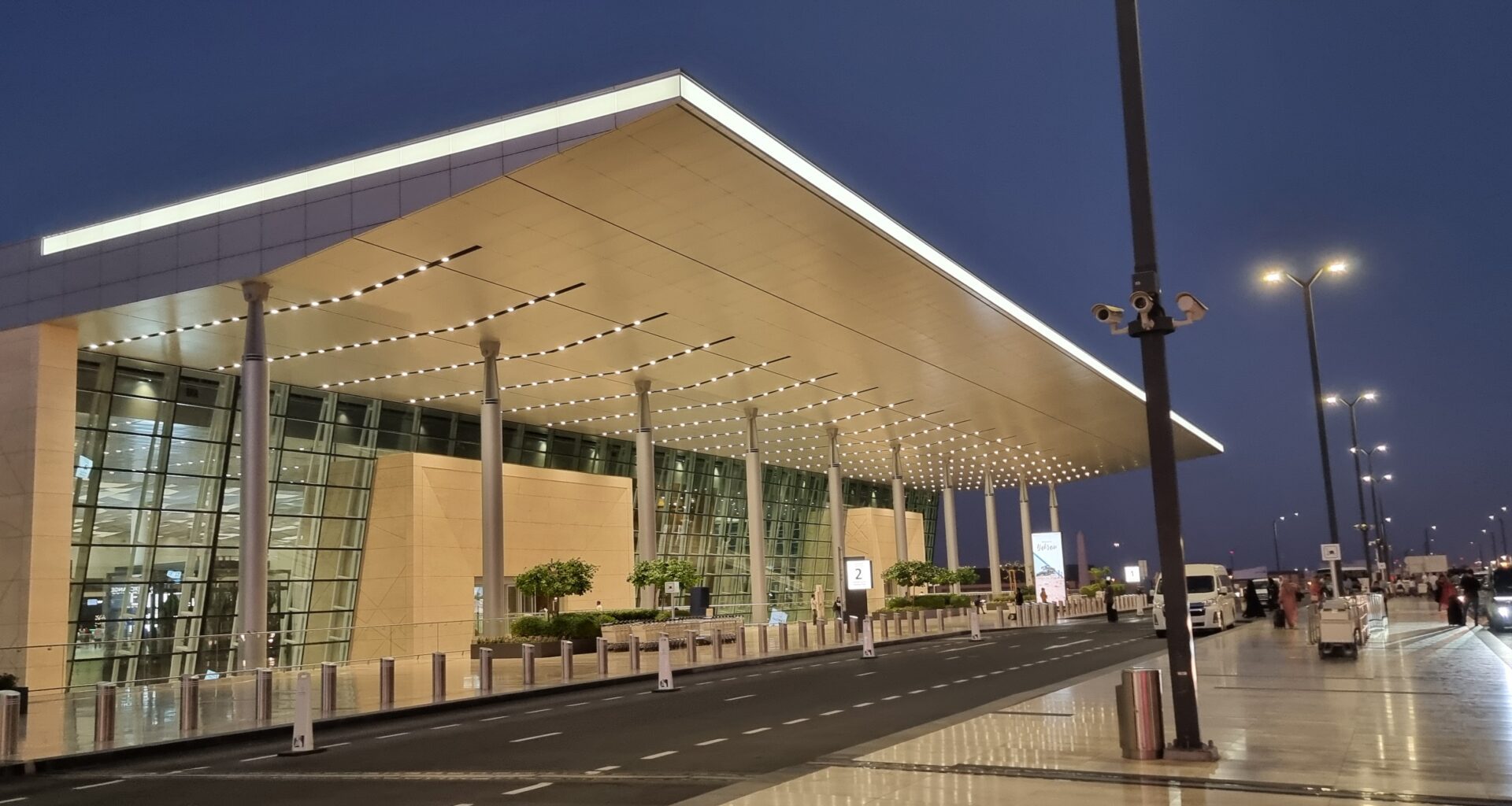 a building with a large roof and a street airport architecture