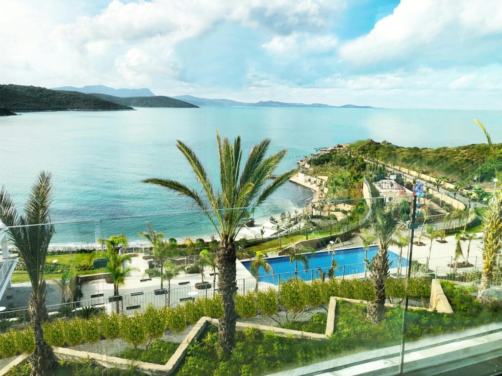 a pool next to a body of water IHG One Rewards