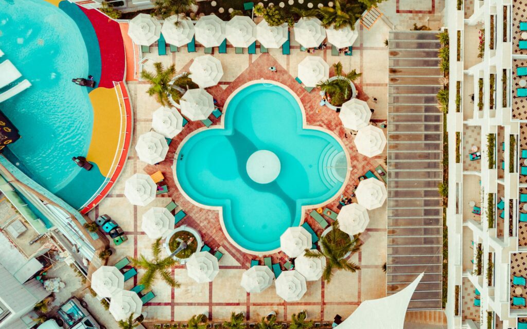 a swimming pool with umbrellas and a pool in the middle Marriott Bonvoy guide