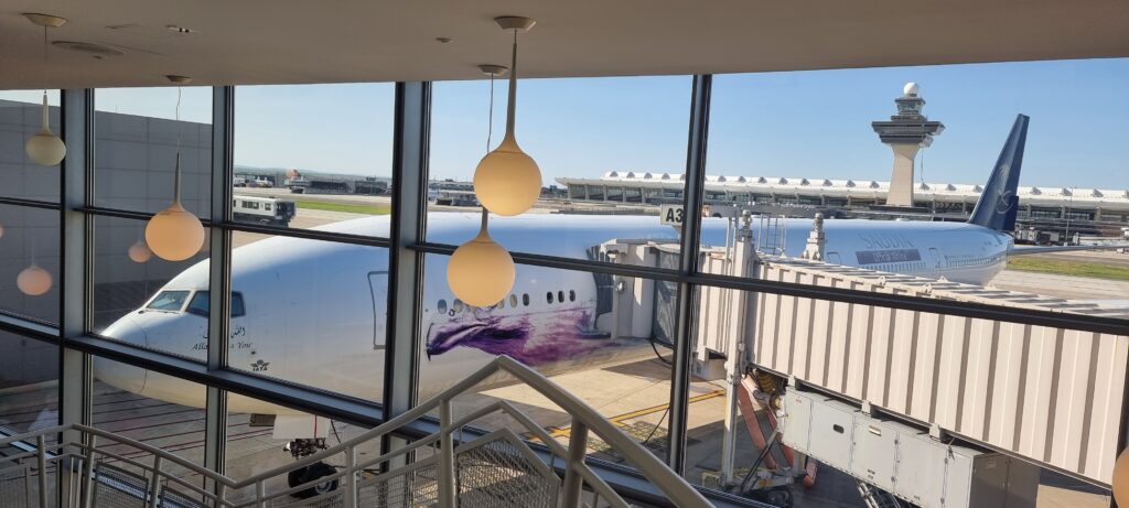a window with a plane in the background