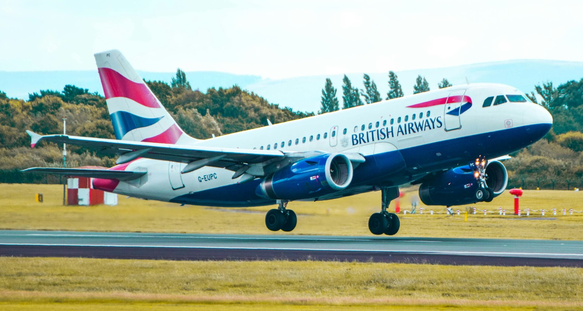 a plane taking off from a runway British Airways Club Guide