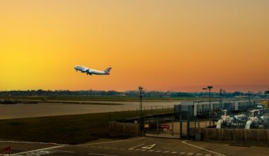 an airplane flying over a runway British Airways Heathrow departures