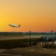 an airplane flying over a runway British Airways Heathrow departures