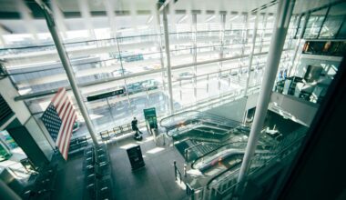 a man standing in a building with escalators Dublin Airport Preclearance