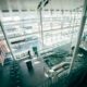 a man standing in a building with escalators Dublin Airport Preclearance