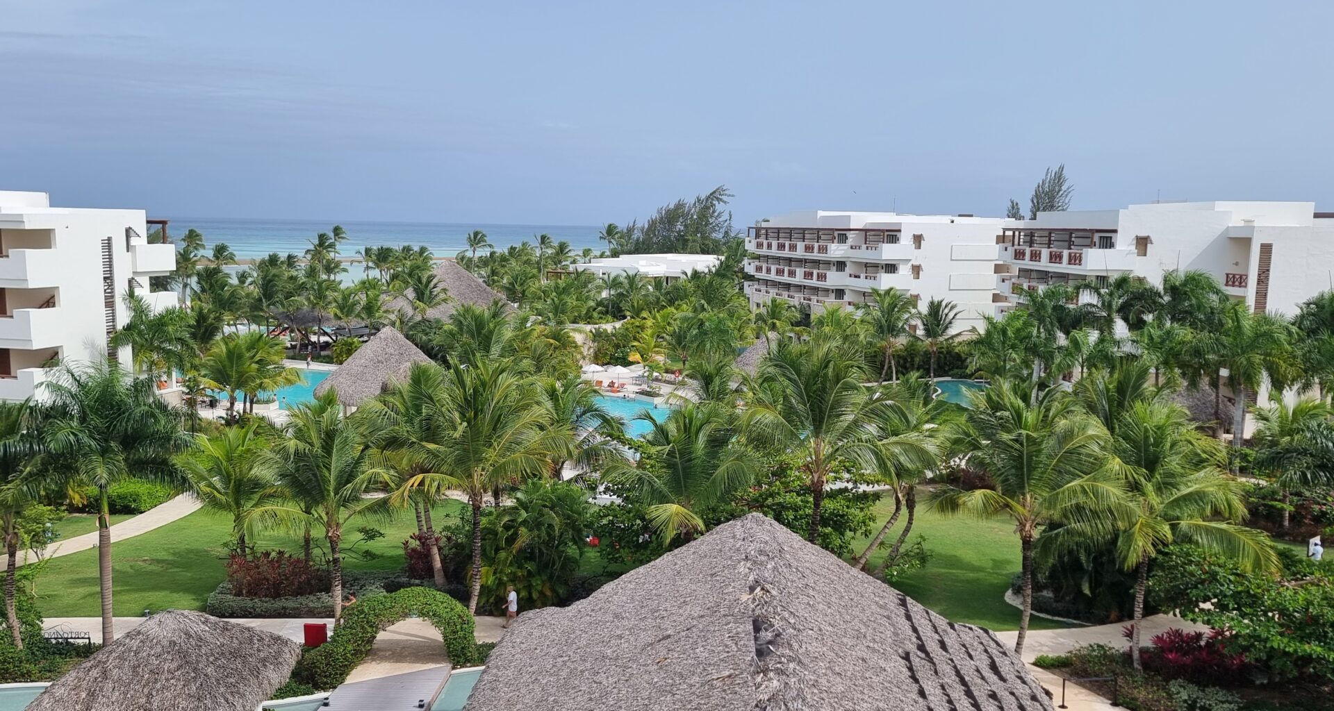 a pool and buildings with palm trees Emirates Dominican Republic