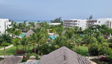 a pool and buildings with palm trees Emirates Dominican Republic