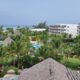 a pool and buildings with palm trees Emirates Dominican Republic