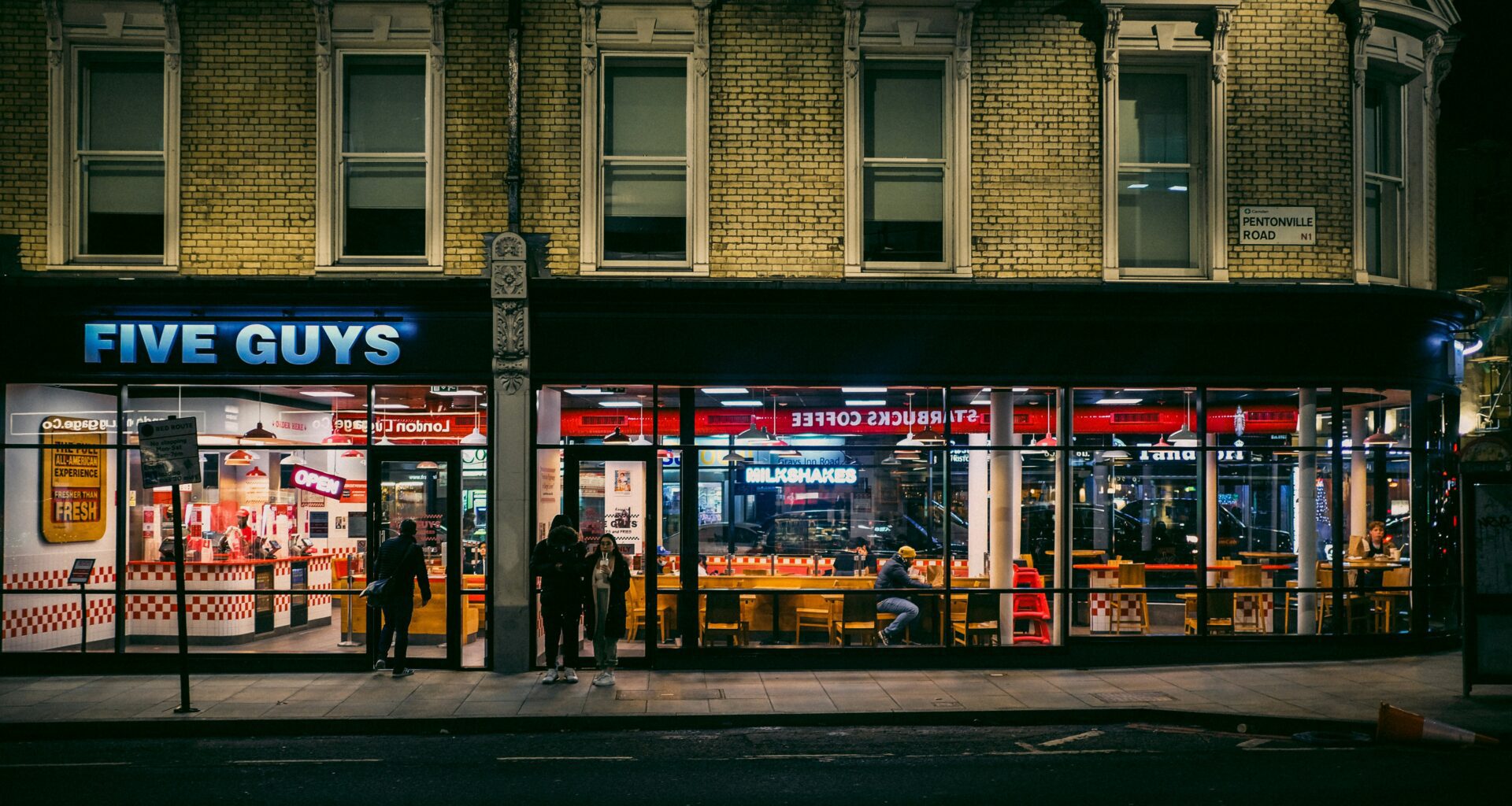 a building with a store front Five Guys Heathrow