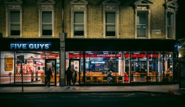 a building with a store front Five Guys Heathrow