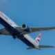 a plane flying in the sky IAG aircraft order 2025