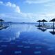 a pool with umbrellas and chairs on the side Virgin Atlantic Credit card