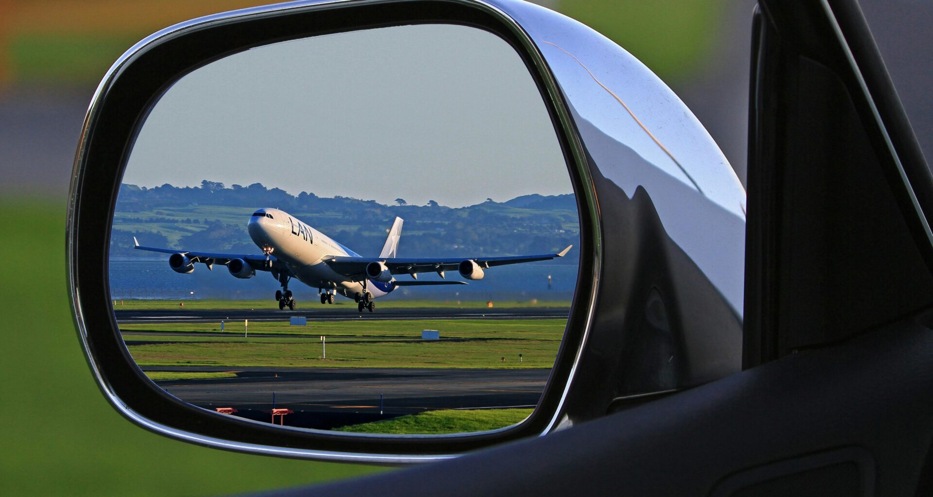a rear view mirror of an airplane taking off Gatwick drop-off charges