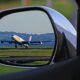 a rear view mirror of an airplane taking off Gatwick drop-off charges
