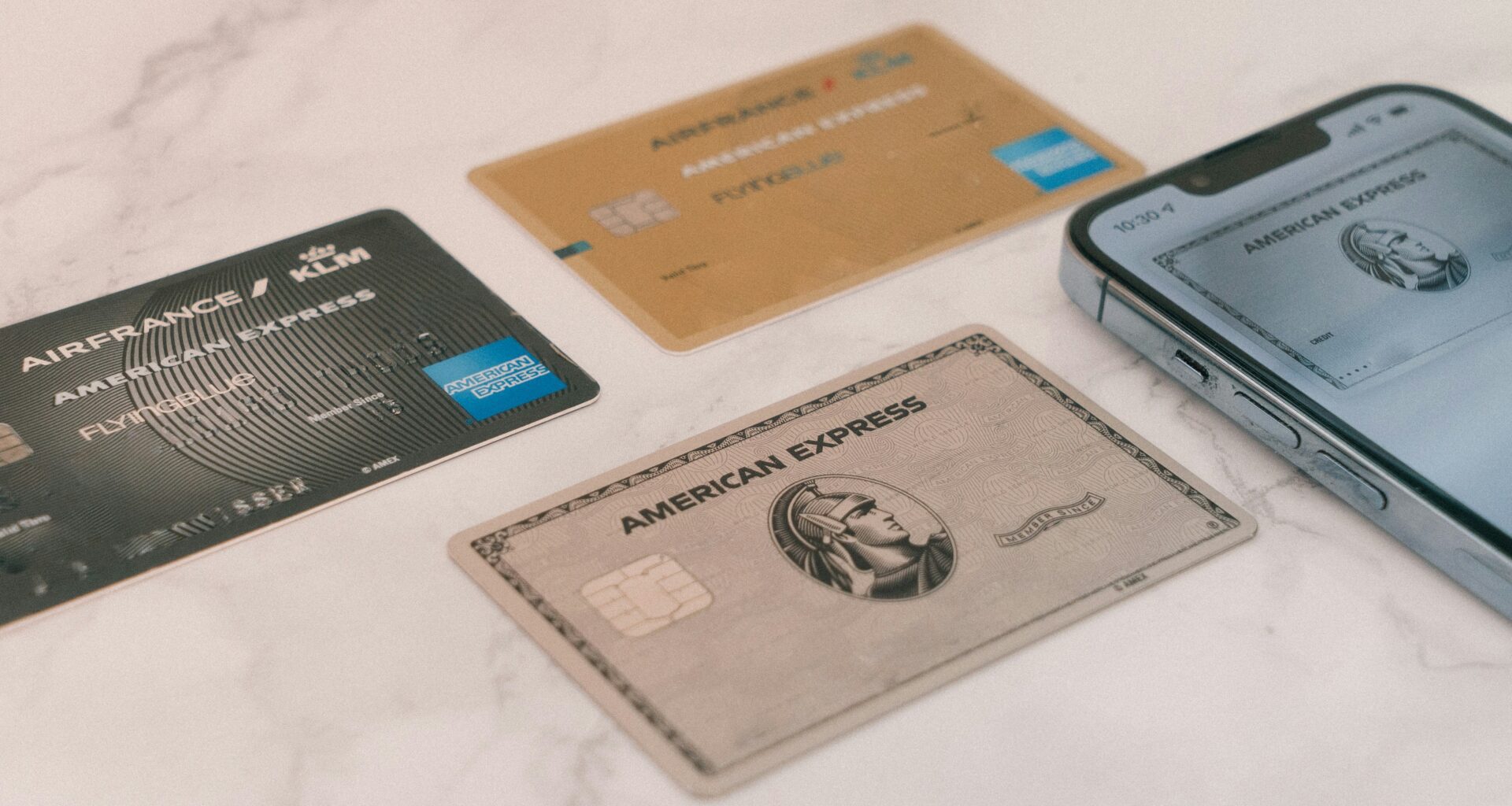 a group of credit cards and a cell phone British Airways American Express