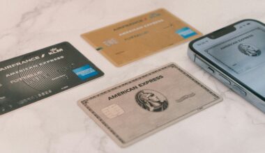 a group of credit cards and a cell phone British Airways American Express
