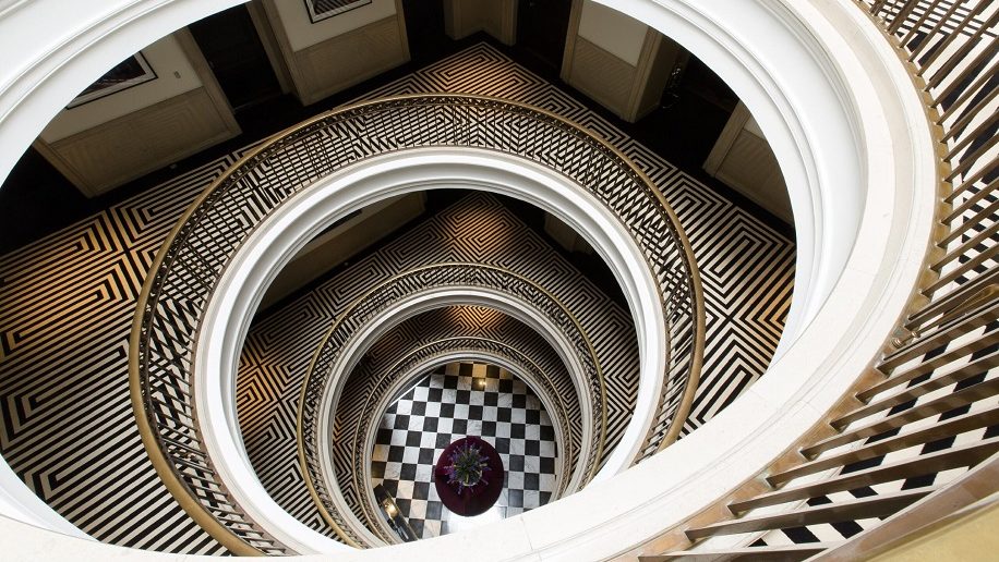 a spiral staircase with a checkered floor Edinburgh Marriott Hotel