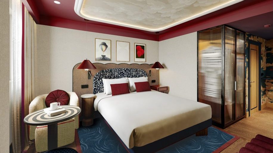 a bedroom with a bed and a chair voco London Waterloo