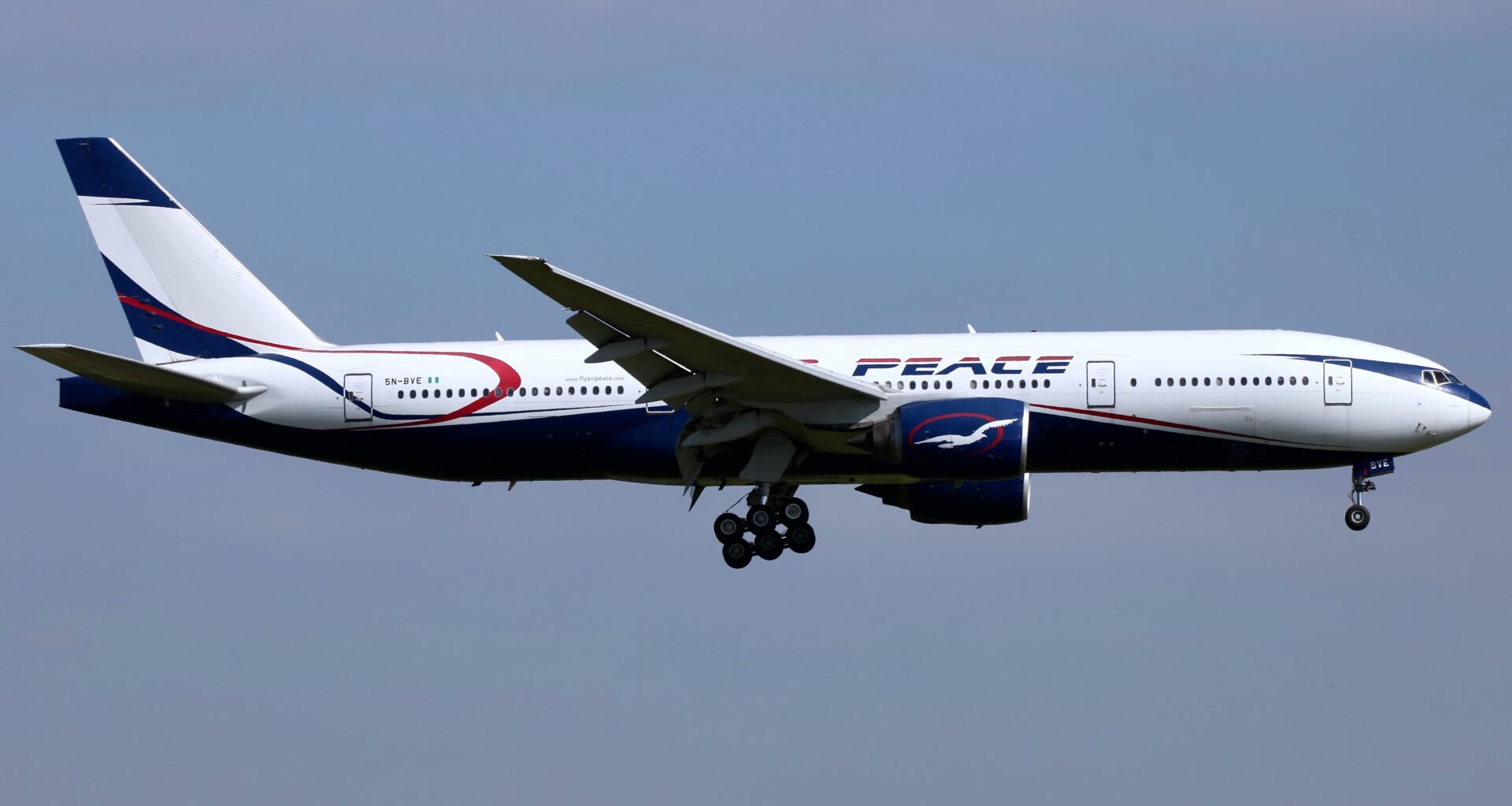 a plane flying in the sky Air Peace London