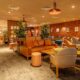 a room with furniture and a brick wall No1 Lounge Heathrow T3