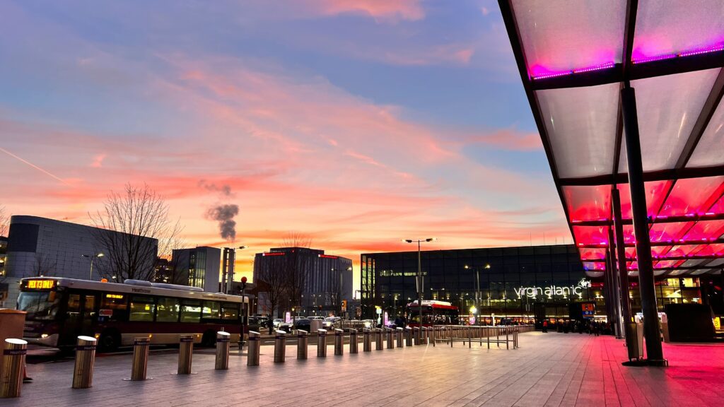 a city with a pink sky Heathrow Fast Track Arrivals