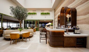 a bar with chairs and tables in a building No1 Lounge Jersey Airport